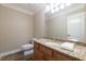 Well-lit bathroom features granite countertops and a decorative framed mirror at 6191 Talmadge Run, Acworth, GA 30101
