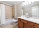 Cozy bathroom with a shower-tub combo, wooden vanity, and neutral tile, ensuring a relaxing and functional space at 6191 Talmadge Run, Acworth, GA 30101