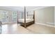Neutral bedroom with a four-poster bed, tile floors, and access to outdoor spaces, promoting relaxation and connection to nature at 6191 Talmadge Run, Acworth, GA 30101