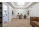 Bright bedroom features neutral carpeting, white walls, and tray ceiling with an adjacent bathroom at 6191 Talmadge Run, Acworth, GA 30101