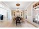 Elegant dining room with chandelier, hardwood floors, and large windows at 6191 Talmadge Run, Acworth, GA 30101