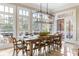 Light-filled dining area featuring a large table, wood chairs, and large windows overlooking a deck at 6191 Talmadge Run, Acworth, GA 30101