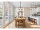 Bright dining room features large windows, wood table with seating for ten, and stylish pendant lighting at 6191 Talmadge Run, Acworth, GA 30101