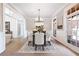 Formal dining room with wainscoting, beautiful wood floors, and a decorative chandelier at 6191 Talmadge Run, Acworth, GA 30101
