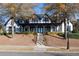 Elegant home with a grand entrance, a meticulously landscaped yard, and mature shade trees at 6191 Talmadge Run, Acworth, GA 30101