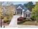 Charming brick home featuring manicured landscaping, a driveway and a welcoming covered front porch at 6191 Talmadge Run, Acworth, GA 30101