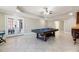 Large game room featuring a pool table and French doors to an outdoor area, providing a versatile entertainment space at 6191 Talmadge Run, Acworth, GA 30101