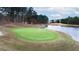 Scenic view of a lush golf course next to a calm lake on a bright day at 6191 Talmadge Run, Acworth, GA 30101