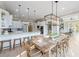 Bright kitchen features a long breakfast bar, an island, and a large dining table for entertaining at 6191 Talmadge Run, Acworth, GA 30101