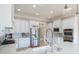 Modern kitchen with stainless steel appliances, white cabinets, and marble countertops at 6191 Talmadge Run, Acworth, GA 30101