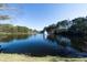 Picturesque view of the lake with a fountain, trees, and blue skies at 6191 Talmadge Run, Acworth, GA 30101