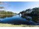 Scenic view of lake featuring fountain and natural treeline and vegetation at 6191 Talmadge Run, Acworth, GA 30101
