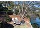 Seating area with fire pit overlooking lake surrounded by lush foliage at 6191 Talmadge Run, Acworth, GA 30101