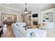 Open-concept living room featuring hardwood floors, built-in shelving, and a cozy fireplace at 6191 Talmadge Run, Acworth, GA 30101