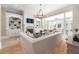 Open-concept living room featuring hardwood floors, fireplace, built-in shelving, and lots of natural light at 6191 Talmadge Run, Acworth, GA 30101