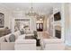 Bright living room with hardwood floors, a fireplace, and a large sectional sofa at 6191 Talmadge Run, Acworth, GA 30101
