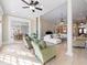 Bright living room featuring hardwood floors, white sofas, fireplace, and decorative columns at 6191 Talmadge Run, Acworth, GA 30101