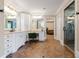 Bright main bathroom featuring dual vanity sinks, a makeup table, glass shower, and stylish tiled floors at 6191 Talmadge Run, Acworth, GA 30101