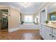 Luxurious main bathroom featuring a soaking tub with a decorative window, separate shower, and elegant vanity at 6191 Talmadge Run, Acworth, GA 30101