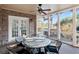 Outdoor patio with screened-in porch, ceiling fan, and wrought-iron seating for six at 6191 Talmadge Run, Acworth, GA 30101