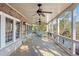 Covered porch with ceiling fans, wrought iron railings, and seating area overlooking trees at 6191 Talmadge Run, Acworth, GA 30101