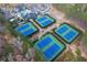 Aerial view showcases well-maintained community tennis courts surrounded by lush greenery at 6191 Talmadge Run, Acworth, GA 30101