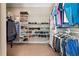 Spacious walk-in closet with custom shelving for shoes, hats, and hanging clothes, ensuring an organized storage solution at 6191 Talmadge Run, Acworth, GA 30101