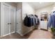Functional walk-in closet with ample hanging space, shelving units, and drawers for optimal organization and storage at 6191 Talmadge Run, Acworth, GA 30101