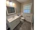 Updated bathroom with white vanity, vinyl flooring, and a new toilet at 175 Smith Ferguson Rd, Dallas, GA 30157