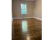 Bedroom with hardwood floors and a large window at 175 Smith Ferguson Rd, Dallas, GA 30157