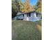 Side view of a white house with gray steps and a grassy yard at 175 Smith Ferguson Rd, Dallas, GA 30157