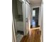 Clean hallway with hardwood floors and barn door leading to bathroom at 175 Smith Ferguson Rd, Dallas, GA 30157