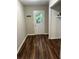 Bright laundry room with dark wood-look vinyl flooring and exterior access at 175 Smith Ferguson Rd, Dallas, GA 30157