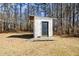 Exterior shed with a black door and wooden ramp at 175 Smith Ferguson Rd, Dallas, GA 30157