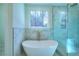 Spa-like bathroom with a freestanding soaking tub and a glass shower at 211 Iroquois Ct, Covington, GA 30014