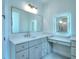 Elegant bathroom with dual vanities, quartz countertops, and a large mirror at 211 Iroquois Ct, Covington, GA 30014