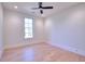 Spacious bedroom with hardwood floors and large window at 211 Iroquois Ct, Covington, GA 30014