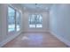 Formal dining room with hardwood floors, chandelier, and large windows at 211 Iroquois Ct, Covington, GA 30014