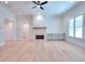 Spacious living room with hardwood floors, fireplace, and large windows at 211 Iroquois Ct, Covington, GA 30014