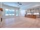 Bright living room with hardwood floors, fireplace, and wooded views at 211 Iroquois Ct, Covington, GA 30014