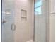 Glass shower with light gray subway tile and built-in shelf at 211 Iroquois Ct, Covington, GA 30014