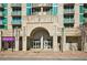 Exterior building entrance to condominiums with shops, concrete facade, and balconies above at 361 17Th Nw St # 2208, Atlanta, GA 30363