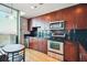 Contemporary kitchen with black granite countertop, stainless steel appliances, and hardwood floors at 361 17Th Nw St # 2208, Atlanta, GA 30363