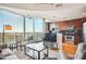 Bright living room featuring hardwood floors, a large window with city views, and a modern kitchen at 361 17Th Nw St # 2208, Atlanta, GA 30363