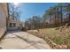 Long concrete patio in a large backyard with grass and trees at 4706 Warrior Se Way, Mableton, GA 30126