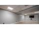 Finished basement with media area and neutral walls at 4706 Warrior Se Way, Mableton, GA 30126