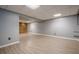 Finished basement with wood-look floors, a stone accent wall, and a blank canvas at 4706 Warrior Se Way, Mableton, GA 30126