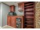 Basement bar with wood cabinets, shelving, and a mini-fridge at 4706 Warrior Se Way, Mableton, GA 30126