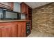 Basement wet bar area, complete with a microwave, mini-fridge, and stone accent wall at 4706 Warrior Se Way, Mableton, GA 30126