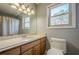 Bright bathroom with light wood cabinets and large window at 4706 Warrior Se Way, Mableton, GA 30126